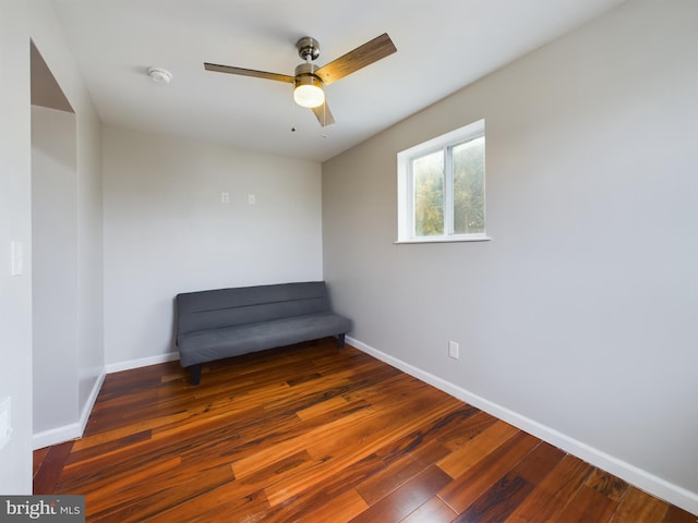 unfurnished room with ceiling fan and dark hardwood / wood-style flooring