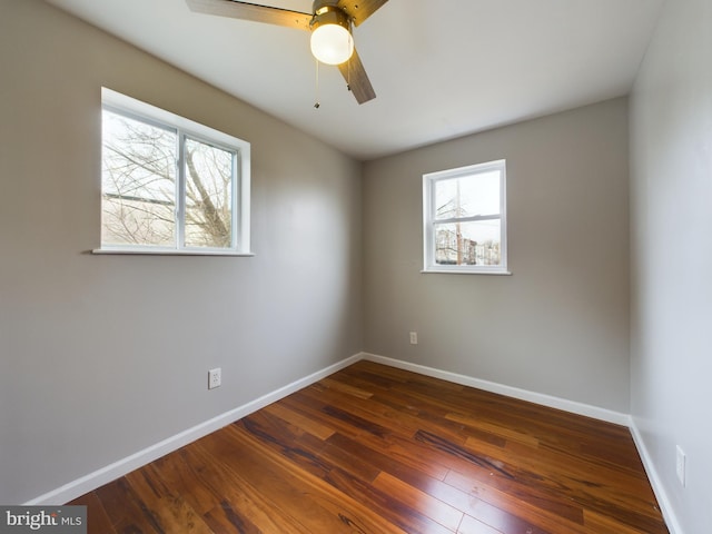 unfurnished room with ceiling fan and dark hardwood / wood-style flooring