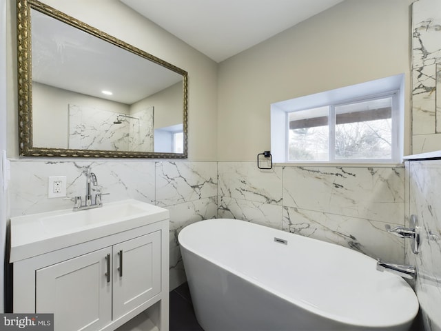 bathroom featuring vanity and a tub