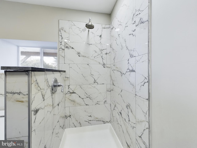 bathroom with tiled shower