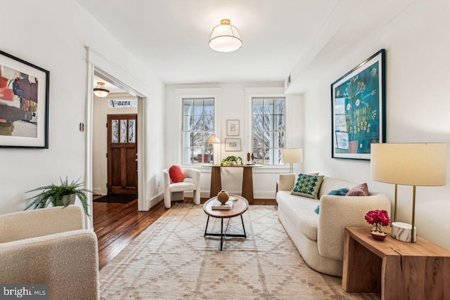 sitting room with hardwood / wood-style flooring