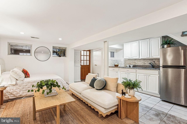 living room with sink and light tile patterned floors