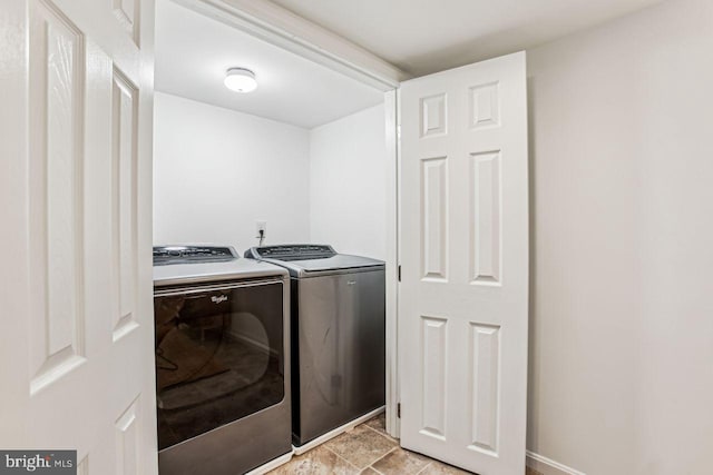 laundry area with washing machine and clothes dryer