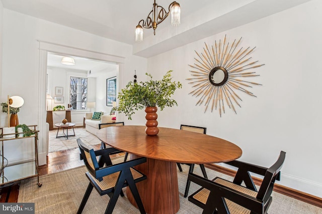 dining space featuring a chandelier and light wood-type flooring