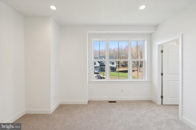 spare room with light carpet