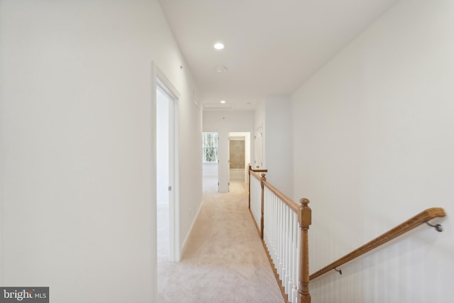 hallway with light colored carpet