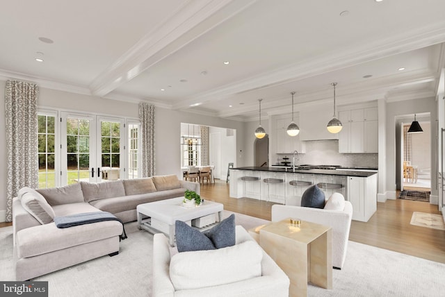 living area with light wood-type flooring, beam ceiling, crown molding, and recessed lighting