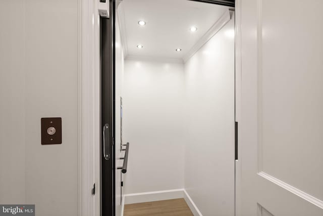 details with baseboards, elevator, wood finished floors, crown molding, and recessed lighting