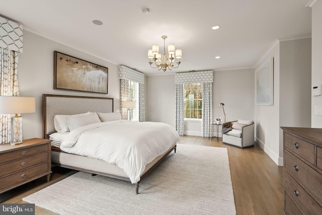 bedroom featuring a notable chandelier, recessed lighting, ornamental molding, wood finished floors, and baseboards