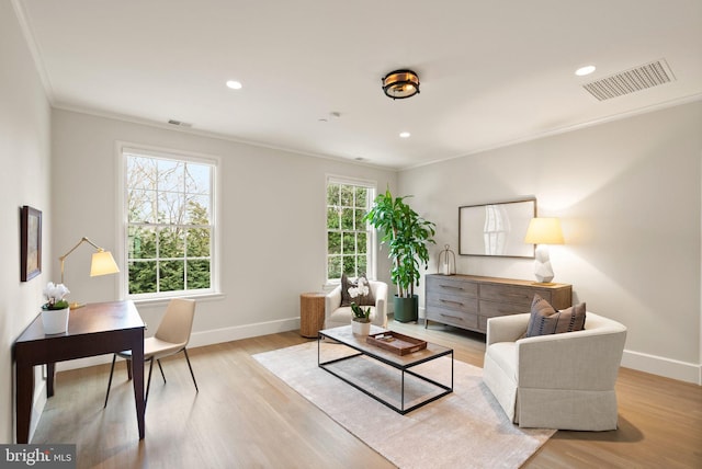 living room with light wood-type flooring, baseboards, and visible vents