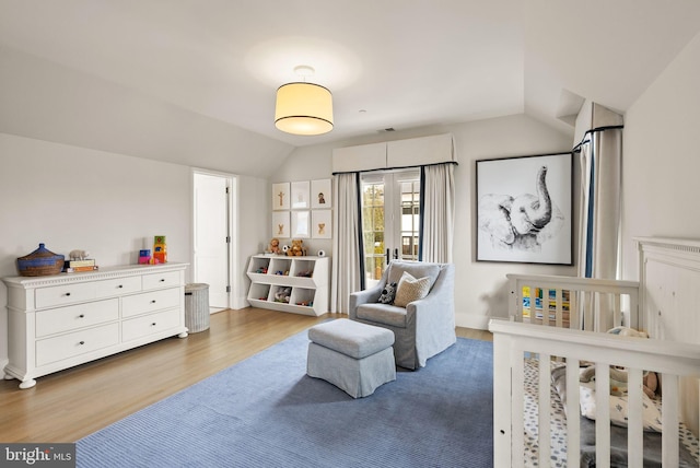 bedroom featuring vaulted ceiling and wood finished floors