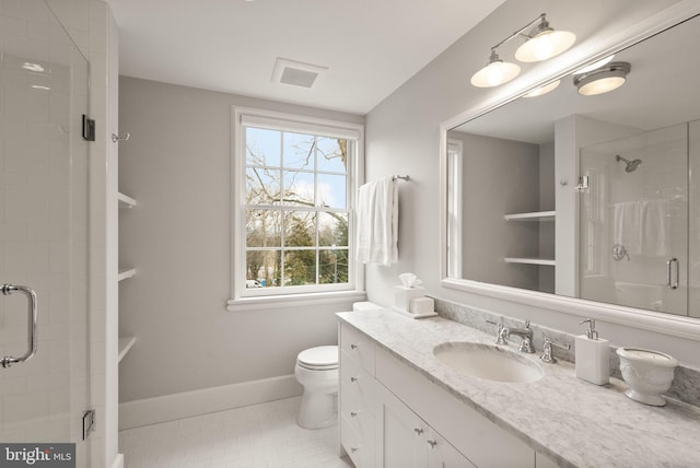 bathroom with baseboards, toilet, tile patterned floors, vanity, and a shower stall