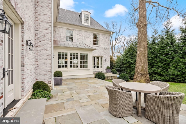 view of patio with outdoor dining area and french doors