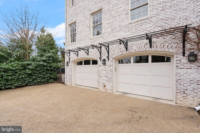 garage with concrete driveway