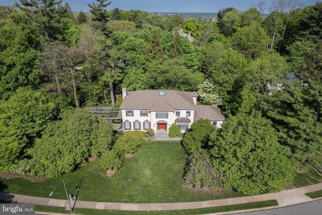 birds eye view of property featuring a view of trees