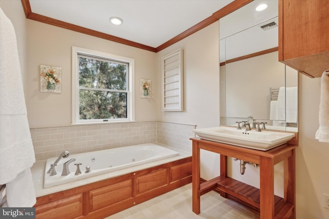 bathroom with ornamental molding, a tub with jets, and visible vents