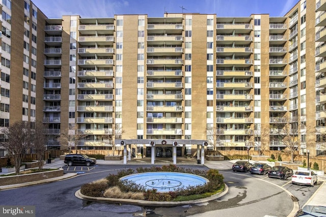 view of building exterior featuring uncovered parking