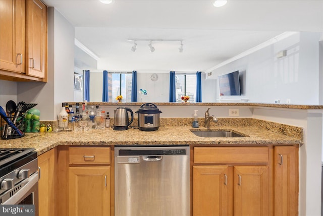 kitchen with stainless steel appliances, light stone counters, a sink, and crown molding