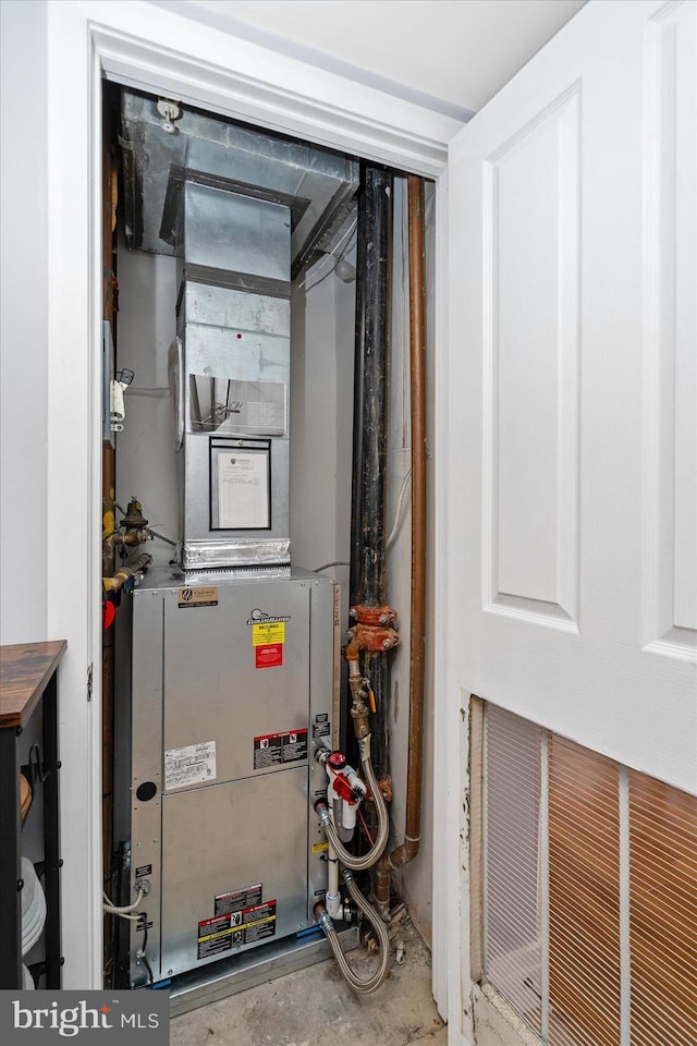 utility room featuring heating unit