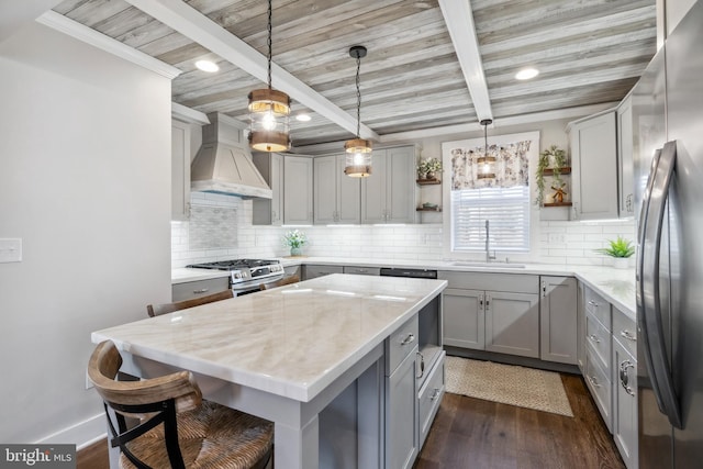 kitchen featuring open shelves, stainless steel appliances, gray cabinetry, a sink, and premium range hood