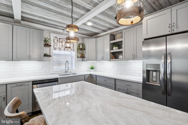 kitchen with gray cabinets, appliances with stainless steel finishes, open shelves, and a sink