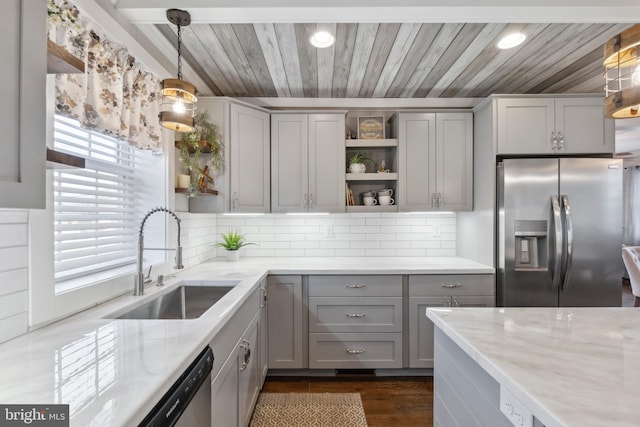 kitchen featuring open shelves, stainless steel appliances, tasteful backsplash, gray cabinets, and a sink