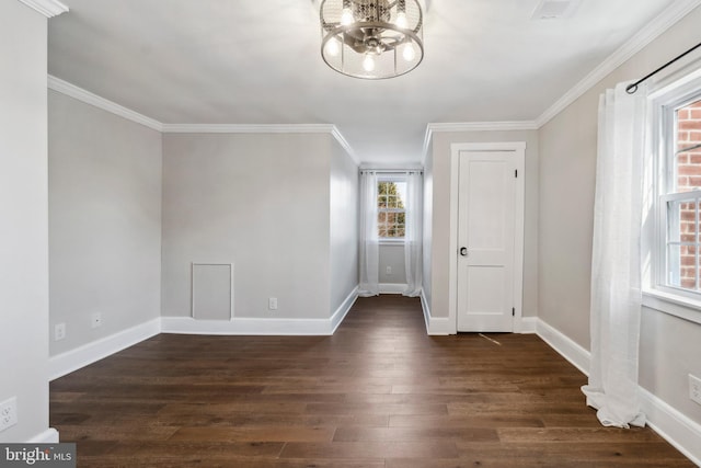 interior space with dark wood-style floors, a chandelier, ornamental molding, and baseboards