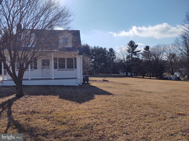 view of yard featuring covered porch and central AC unit