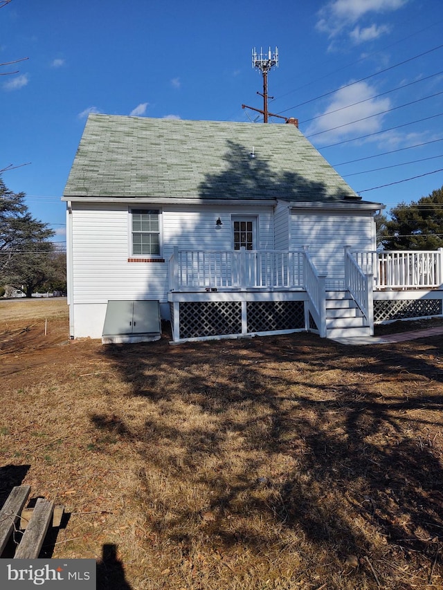 rear view of house featuring a deck