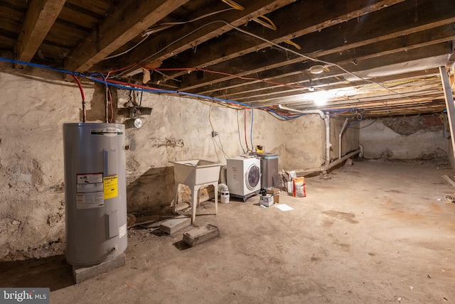 basement with washer and dryer, sink, and water heater