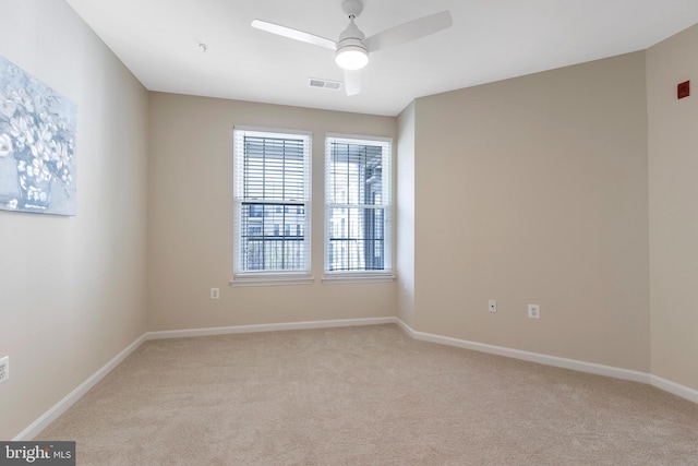 empty room with light colored carpet and ceiling fan