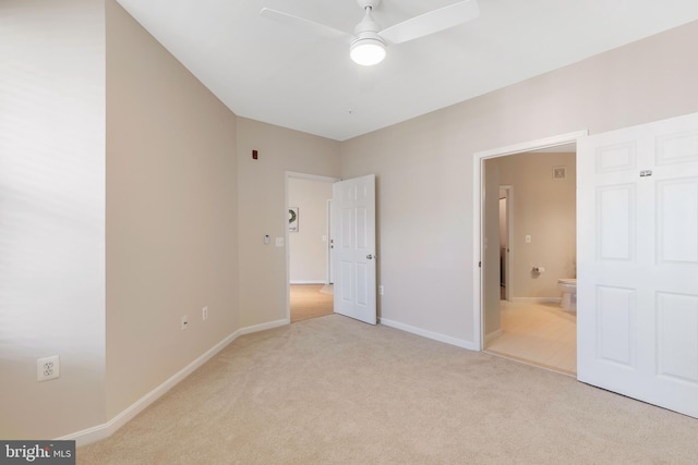 unfurnished bedroom with light colored carpet, ceiling fan, and ensuite bathroom