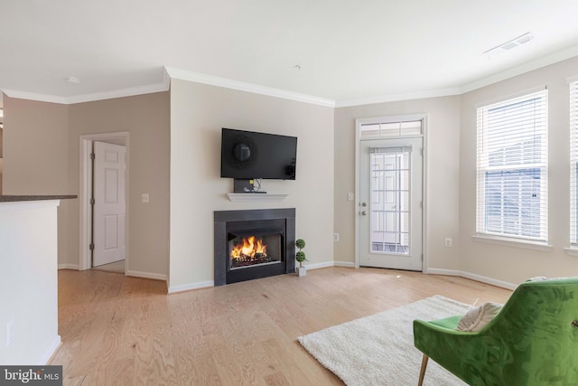 living room featuring ornamental molding and light hardwood / wood-style floors