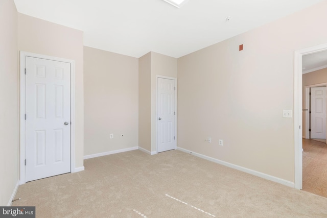 unfurnished bedroom featuring light carpet