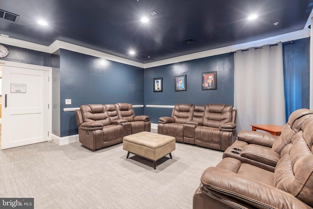 carpeted home theater room with ornamental molding