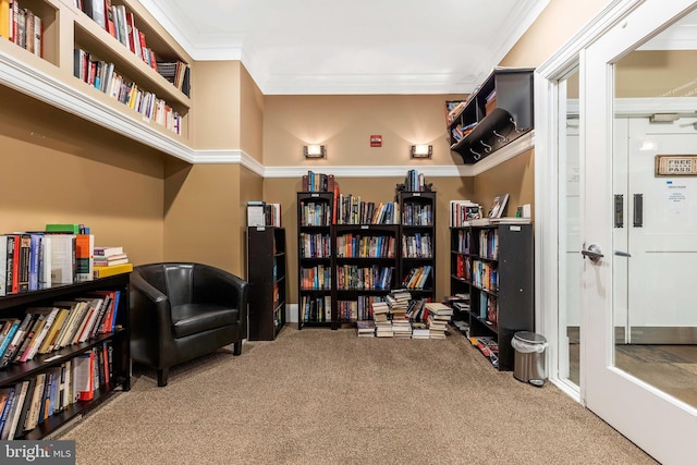 sitting room with crown molding and carpet