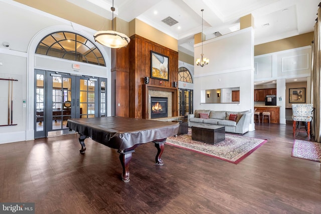 recreation room with french doors, pool table, dark hardwood / wood-style floors, beamed ceiling, and a high ceiling