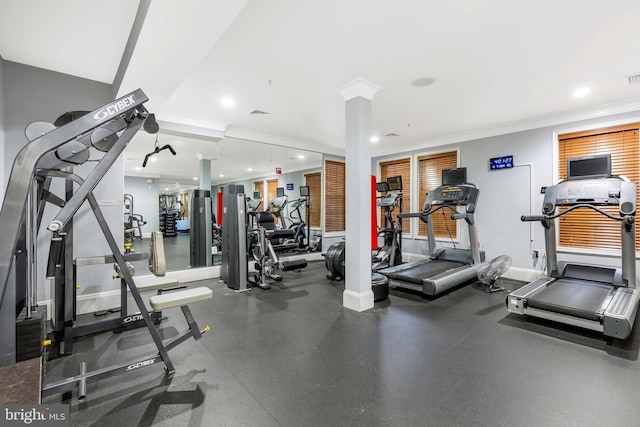 gym featuring ornamental molding and ornate columns