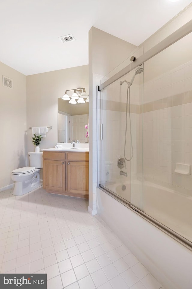 full bathroom with vanity, tile patterned floors, shower / bath combination with glass door, and toilet