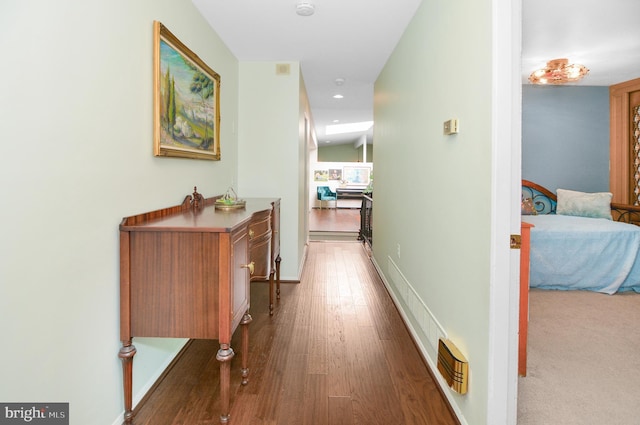 corridor with recessed lighting, visible vents, baseboards, and wood finished floors