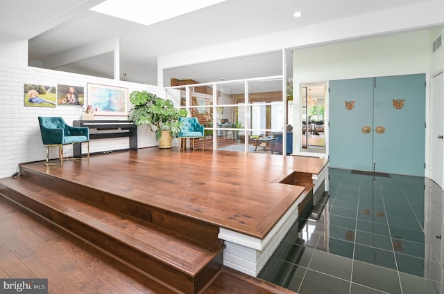 dining space with a skylight, recessed lighting, visible vents, and dark tile patterned flooring