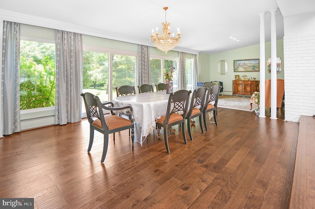 dining room featuring decorative columns, an inviting chandelier, dark wood-type flooring, a baseboard heating unit, and vaulted ceiling