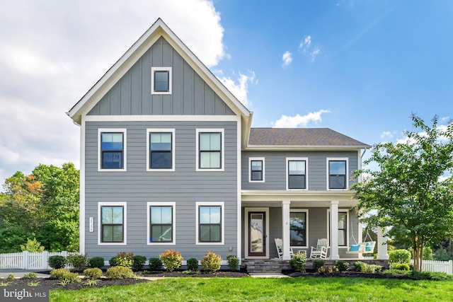 view of front of home with covered porch and a front yard