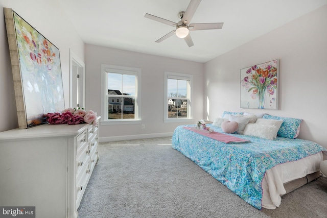 bedroom featuring ceiling fan and light carpet