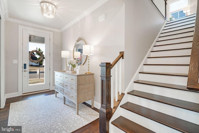 foyer entrance with dark hardwood / wood-style flooring, crown molding, and a healthy amount of sunlight