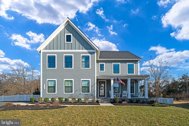 view of front of home featuring covered porch and a front lawn