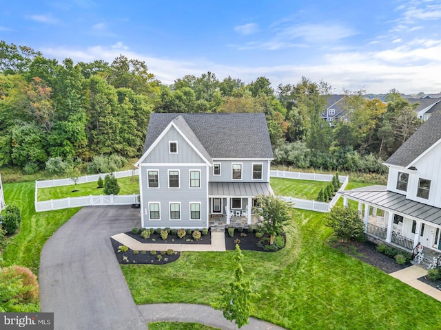 view of front facade with a front yard and a porch