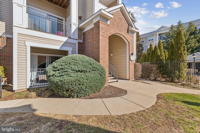 view of exterior entry with brick siding