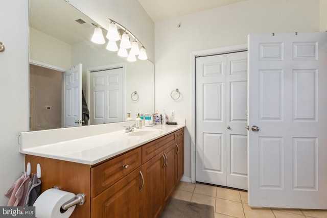 bathroom featuring a closet, vanity, and tile patterned floors