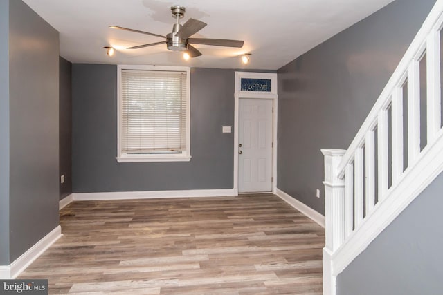 foyer entrance with ceiling fan and light hardwood / wood-style flooring